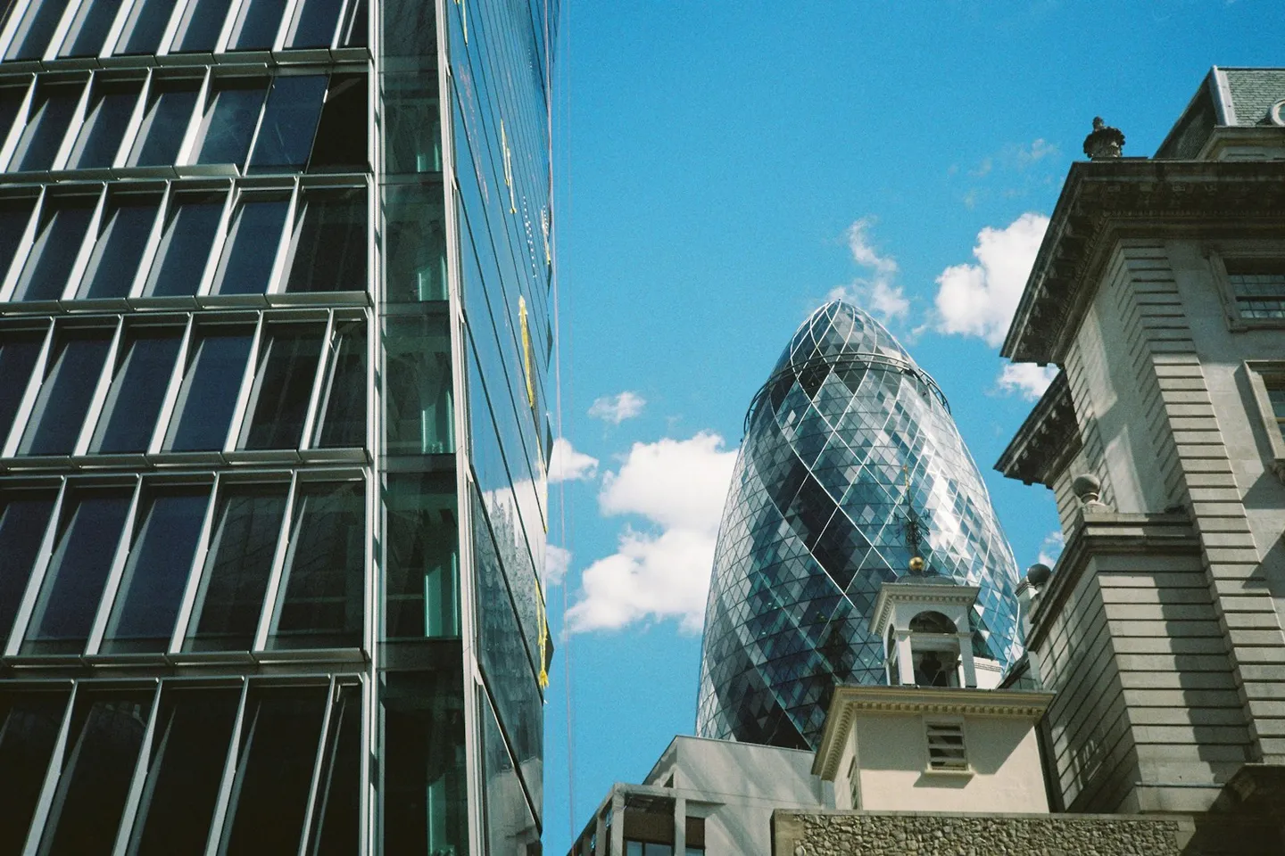 30 St Mary Axe (the Gherkin) in the City of London under a blue sky, a landmark commercial building