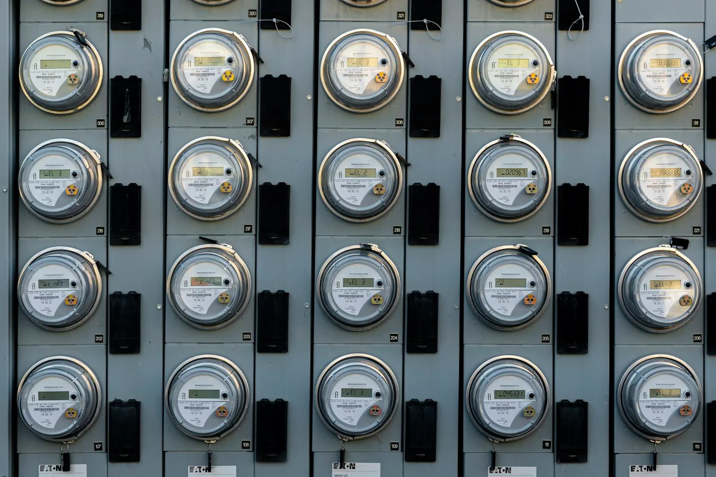 Close-up of a commercial electrical meter on a building wall, the kind of interval meter that feeds energy monitoring and targeting