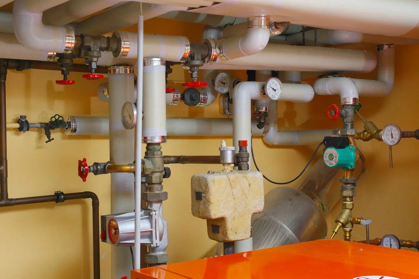 Plant room pipes and valves in a commercial building mechanical space